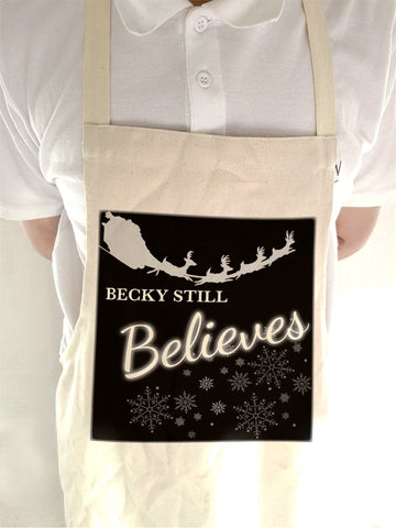 CC05 - Personalised Christmas Name inserted Still Believes Canvas Apron in Black or Red